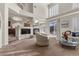 Inviting living room with fireplace, plush chair, and an open layout with lots of natural light at 4439 Melrose Abbey Pl, Las Vegas, NV 89141