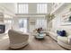 Airy living room with fireplace, comfortable seating, and sliding glass doors to the patio at 4439 Melrose Abbey Pl, Las Vegas, NV 89141