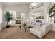 Bright living room with a cozy fireplace, modern decor, and an open floor plan at 4439 Melrose Abbey Pl, Las Vegas, NV 89141