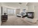 Spacious main bedroom featuring a cozy fireplace, large windows with shutters, and neutral decor at 4439 Melrose Abbey Pl, Las Vegas, NV 89141