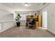 Bright home office featuring built-in cabinets, a desk, a comfortable chair, and natural light from the window at 4439 Melrose Abbey Pl, Las Vegas, NV 89141