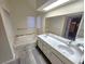 Bathroom boasts a large vanity, a luxurious soaking tub, and wood-look flooring at 4708 Obannon Dr # C, Las Vegas, NV 89102