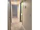 Hallway with carpet, neutral-colored walls, and doors to bedrooms and bathroom at 4708 Obannon Dr # C, Las Vegas, NV 89102