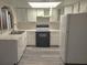 Modern kitchen with white cabinets, black appliances, and grey wood-look vinyl flooring at 4708 Obannon Dr # C, Las Vegas, NV 89102