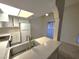 Bright kitchen features white cabinets, stainless steel sink, and modern appliances at 4708 Obannon Dr # C, Las Vegas, NV 89102