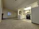 Spacious living room with carpeted floors and views into the kitchen at 4708 Obannon Dr # C, Las Vegas, NV 89102