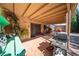 Spacious back patio, featuring tile, covered seating area with grill, and a well manicured backyard at 5873 Corazon Dr, Las Vegas, NV 89103