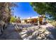 Backyard with desert landscaping, playhouse, and mature trees at 5873 Corazon Dr, Las Vegas, NV 89103