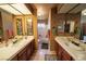 Bathroom featuring dual sinks, tiled floors, and a bathtub-shower combination at 5873 Corazon Dr, Las Vegas, NV 89103