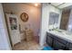 Bathroom featuring vanity, cabinet, framed art, decorative towels, and tiled floor at 5873 Corazon Dr, Las Vegas, NV 89103
