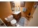 Cozy half bathroom with a toilet, sink and wood vanity at 5873 Corazon Dr, Las Vegas, NV 89103