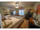 Spacious bedroom featuring a ceiling fan, mirrored closet doors, and a queen-size bed at 5873 Corazon Dr, Las Vegas, NV 89103
