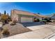 Charming single-story home featuring a desert landscape and a spacious two-car garage at 5873 Corazon Dr, Las Vegas, NV 89103