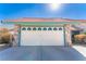 Home featuring a two-car garage with eye-catching tile roof and stone facade at 5873 Corazon Dr, Las Vegas, NV 89103