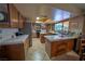 Well-lit kitchen with central island, stainless steel appliances, and tiled countertops at 5873 Corazon Dr, Las Vegas, NV 89103