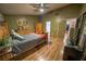 Spacious main bedroom with wood laminate flooring, ceiling fan, and ensuite bathroom at 5873 Corazon Dr, Las Vegas, NV 89103