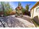 Backyard with a custom-built wooden playhouse, desert landscaping, and mature trees at 5873 Corazon Dr, Las Vegas, NV 89103