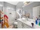 Bright bathroom features a shower and bath, large mirror, and vibrant decor at 5940 Palmilla St # 9, North Las Vegas, NV 89031