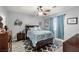 Comfortable bedroom features a ceiling fan, stylish rug, and a well-lit window at 5940 Palmilla St # 9, North Las Vegas, NV 89031