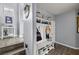 Entryway features a white storage bench with shoe rack, hooks, and shelves at 5940 Palmilla St # 9, North Las Vegas, NV 89031