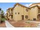 Charming townhome featuring a private entrance with desert landscaping, two-story building and upper and lower balconies at 5940 Palmilla St # 9, North Las Vegas, NV 89031