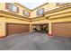 A row of garages with brown doors, some filled with stored items at 5940 Palmilla St # 9, North Las Vegas, NV 89031