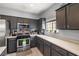 Efficient kitchen features stainless steel appliances, ample counter space, and dark cabinets providing convenience and style at 5940 Palmilla St # 9, North Las Vegas, NV 89031