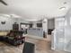 Open-concept living space flowing into the kitchen with an island and stainless steel appliances at 5940 Palmilla St # 9, North Las Vegas, NV 89031