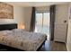 Bright bedroom with a queen bed, dresser, and balcony access at 6250 W Flamingo Rd # 88, Las Vegas, NV 89103