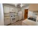 Full kitchen view, white cabinetry, electric range and refrigerator at 6750 Del Rey Ave # 102, Las Vegas, NV 89146