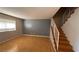 Light and airy living room featuring light wood laminate flooring and a staircase at 6750 Del Rey Ave # 102, Las Vegas, NV 89146