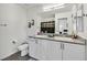 Double vanity bathroom with granite countertops and large mirror at 6867 Evening Orchid St, North Las Vegas, NV 89086