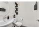 Clean bathroom with white vanity, toilet and dark wood floor at 6867 Evening Orchid St, North Las Vegas, NV 89086