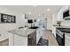 Kitchen boasts granite island, stainless steel appliances, and ample cabinet space at 6867 Evening Orchid St, North Las Vegas, NV 89086