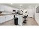 Modern kitchen with white cabinets, granite counters, and stainless steel appliances at 6867 Evening Orchid St, North Las Vegas, NV 89086