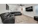 Spacious living room featuring a large sectional sofa and wood-look floors at 6867 Evening Orchid St, North Las Vegas, NV 89086