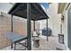 Relaxing patio featuring a pergola, seating, and grill at 6867 Evening Orchid St, North Las Vegas, NV 89086