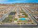 Expansive aerial view showcasing the community's amenities, including a clubhouse, pool, tennis courts, and well-manicured landscaping at 723 Orange Plume Walk # 0, Henderson, NV 89011