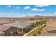 Aerial shot showcases a charming single-story home with a covered porch and beautiful desert landscaping at 723 Orange Plume Walk # 0, Henderson, NV 89011