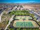 Aerial view featuring tennis courts and green spaces within a well-maintained community at 723 Orange Plume Walk # 0, Henderson, NV 89011