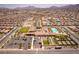 Sweeping aerial shot showing the community's clubhouse, pool, recreational courts, and neatly arranged residential streets at 723 Orange Plume Walk # 0, Henderson, NV 89011