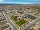 Stunning aerial view of the community clubhouse, pool, and surrounding neighborhood with beautiful mountain views in the distance at 723 Orange Plume Walk # 0, Henderson, NV 89011
