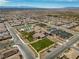 Expansive community aerial view showcasing neighborhood layout with pool, clubhouse and mountain views at 723 Orange Plume Walk # 0, Henderson, NV 89011