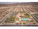 Drone shot showcasing the community center with a swimming pool, tennis courts, shuffleboard, and plentiful parking at 723 Orange Plume Walk # 0, Henderson, NV 89011