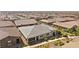 Aerial shot showcases a charming single-story home with a covered porch and beautiful desert landscaping at 723 Orange Plume Walk # 0, Henderson, NV 89011