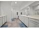 Well-lit bathroom featuring double sinks, vanity area and full-width mirror at 723 Orange Plume Walk # 0, Henderson, NV 89011