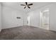 Spacious bedroom with neutral carpet, ceiling fan, and multiple doorways at 723 Orange Plume Walk # 0, Henderson, NV 89011