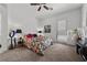 Bright bedroom with a colorful bed, side tables, and a sliding glass door to the outside at 723 Orange Plume Walk # 0, Henderson, NV 89011