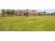 Exterior shot of the community clubhouse with a lush green lawn in the foreground at 723 Orange Plume Walk # 0, Henderson, NV 89011