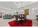 Bright dining area featuring a modern light fixture and a dark wood table on a red rug at 723 Orange Plume Walk # 0, Henderson, NV 89011